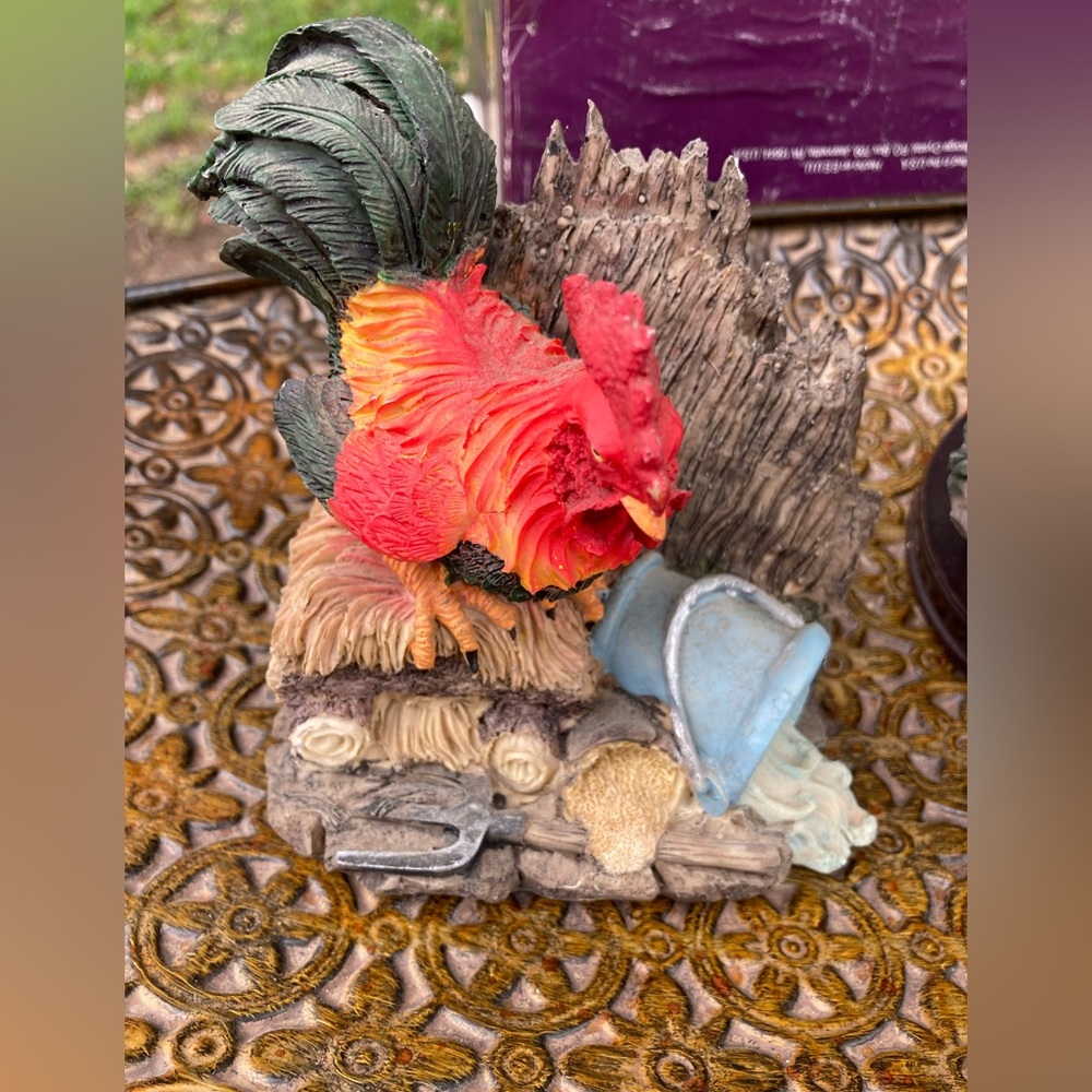 Beautiful red and orange rooster with water can